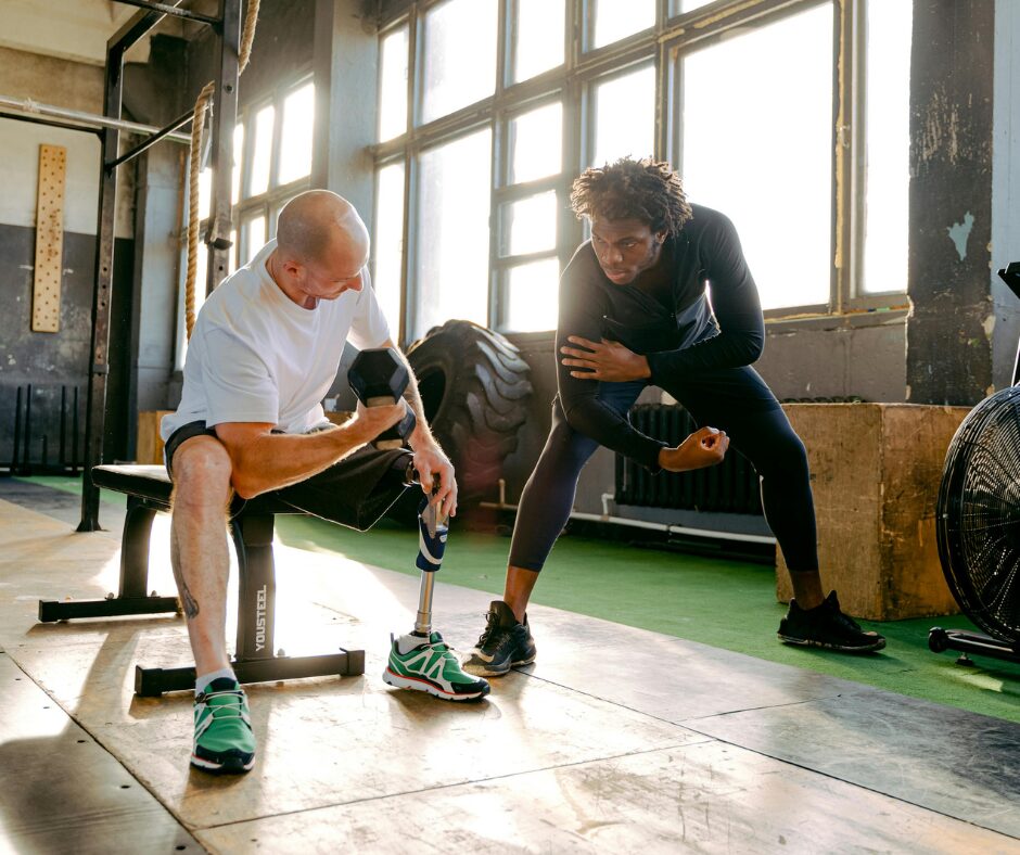 A personal trainer guiding a client through dumbbell exercises during a one-on-one training session.